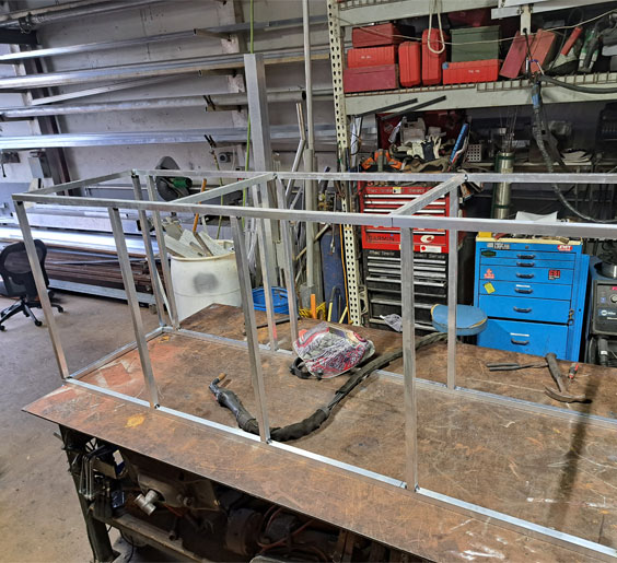 A sturdy metal frame positioned on a table inside Oceanside steel fabricators in Fort Lauderdale workshop