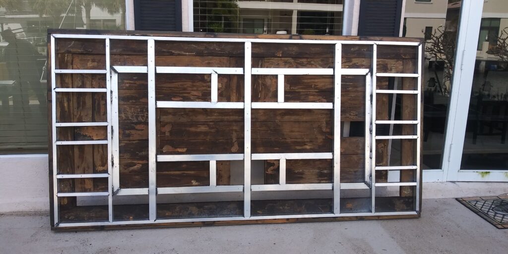 Custom metal frame with wooden panels for decorative or structural use in outdoor setting